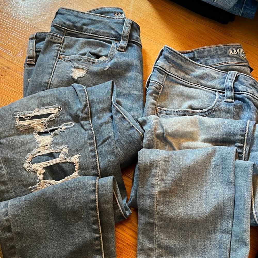 THREE PAIRS of Women’s Size two American Eagle jeans.